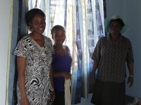 Women together inside a home at S.M.I.L.E. Village